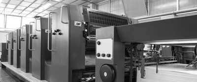 Druckmaschine in einer Produktionshalle, vorbereitet für hochfeste Lacke auf Metalloberflächen.